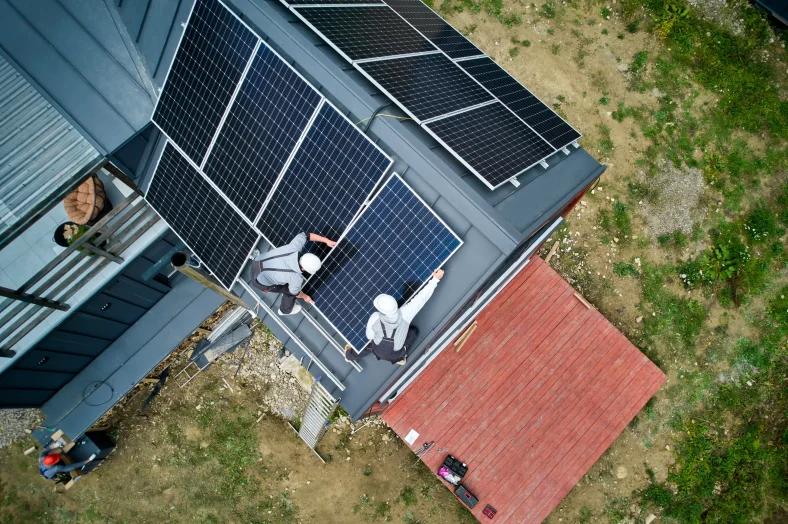 Workers installing a solar panel system outdoors