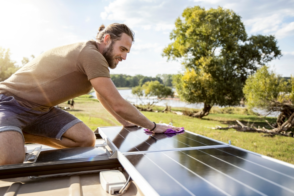 Homeowner is cleaning a solar panel