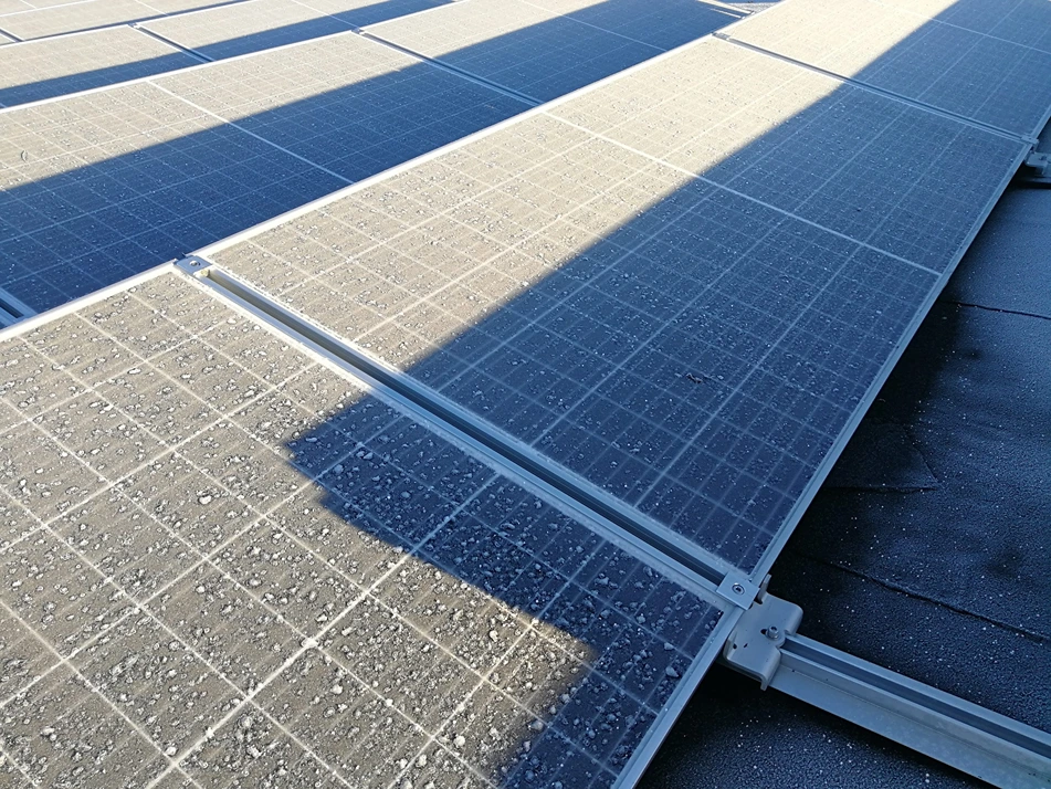 Partially shaded solar panels on the roof of the building