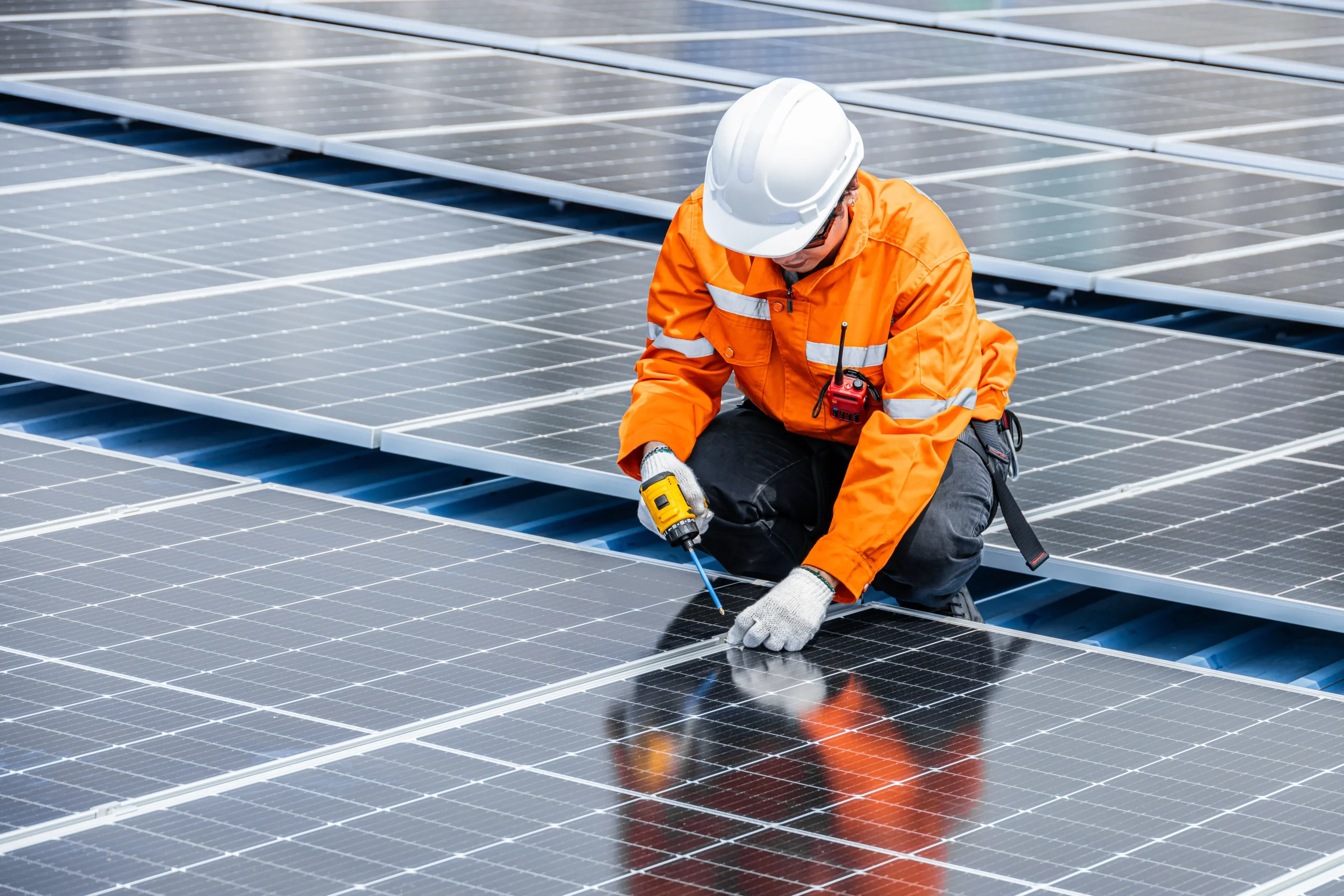 Solar engineer mounts a panel to the roof