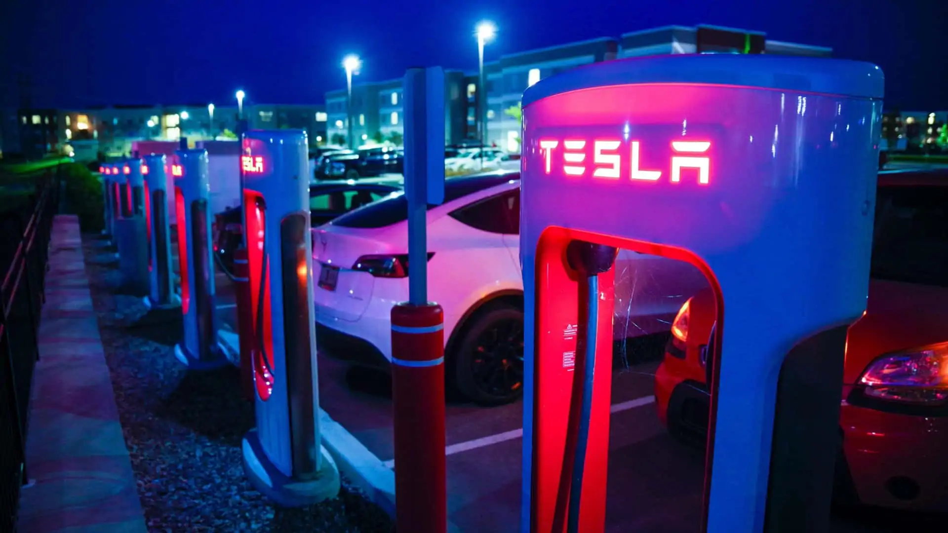 Tesla Superchargers at night at a charging station