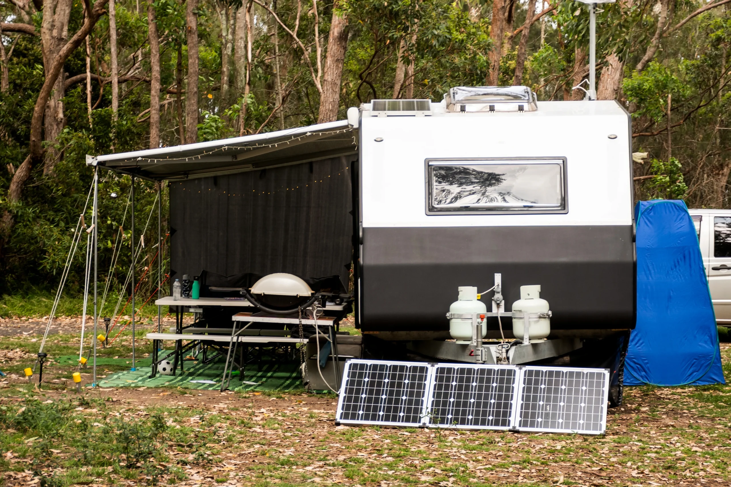 RV caravan on a campsite with camping solar panels