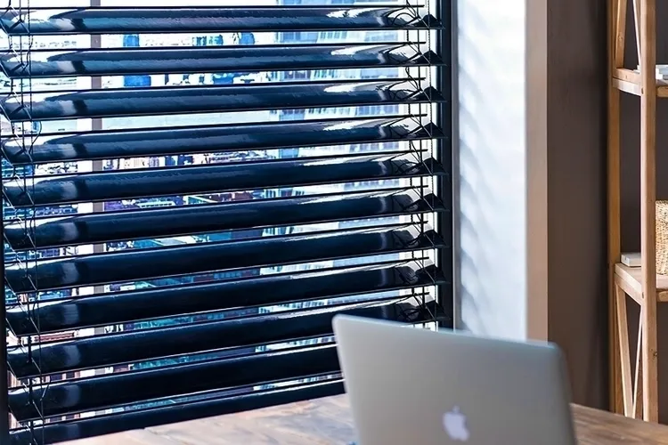 Solar blinds on the window to protect from and harness the sunlight