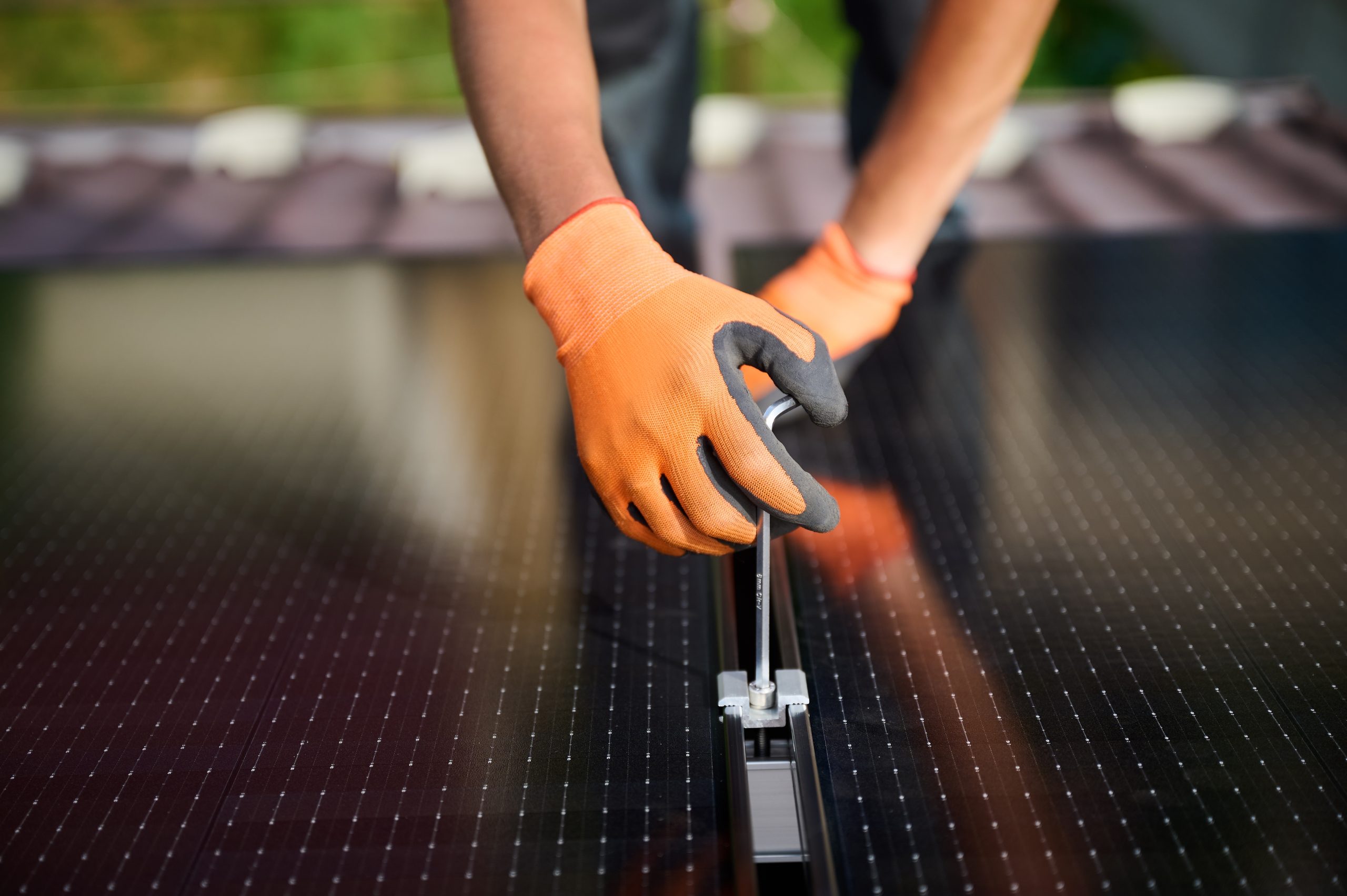 Solar installer mounting the solar panels on the roof of the building