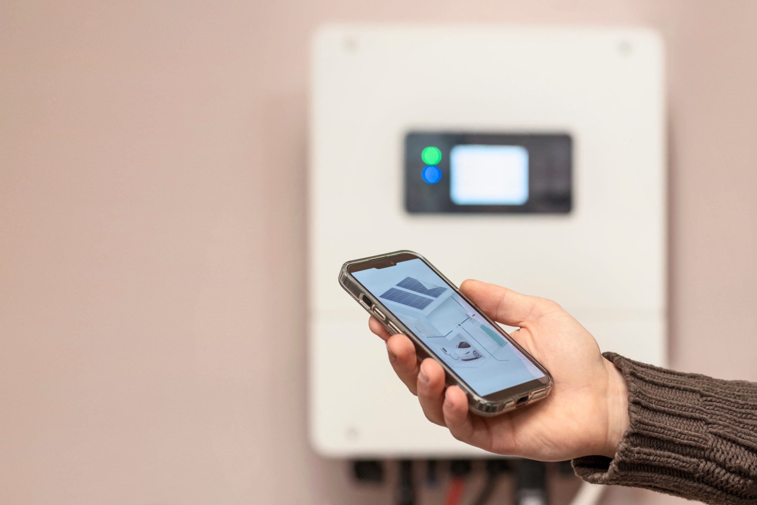 A homeowner using a smartphone app for a solar inverter