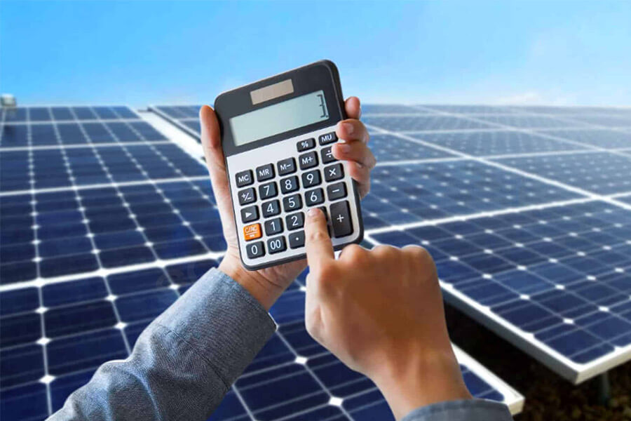 A man using a measuring tape to determine the solar panel size