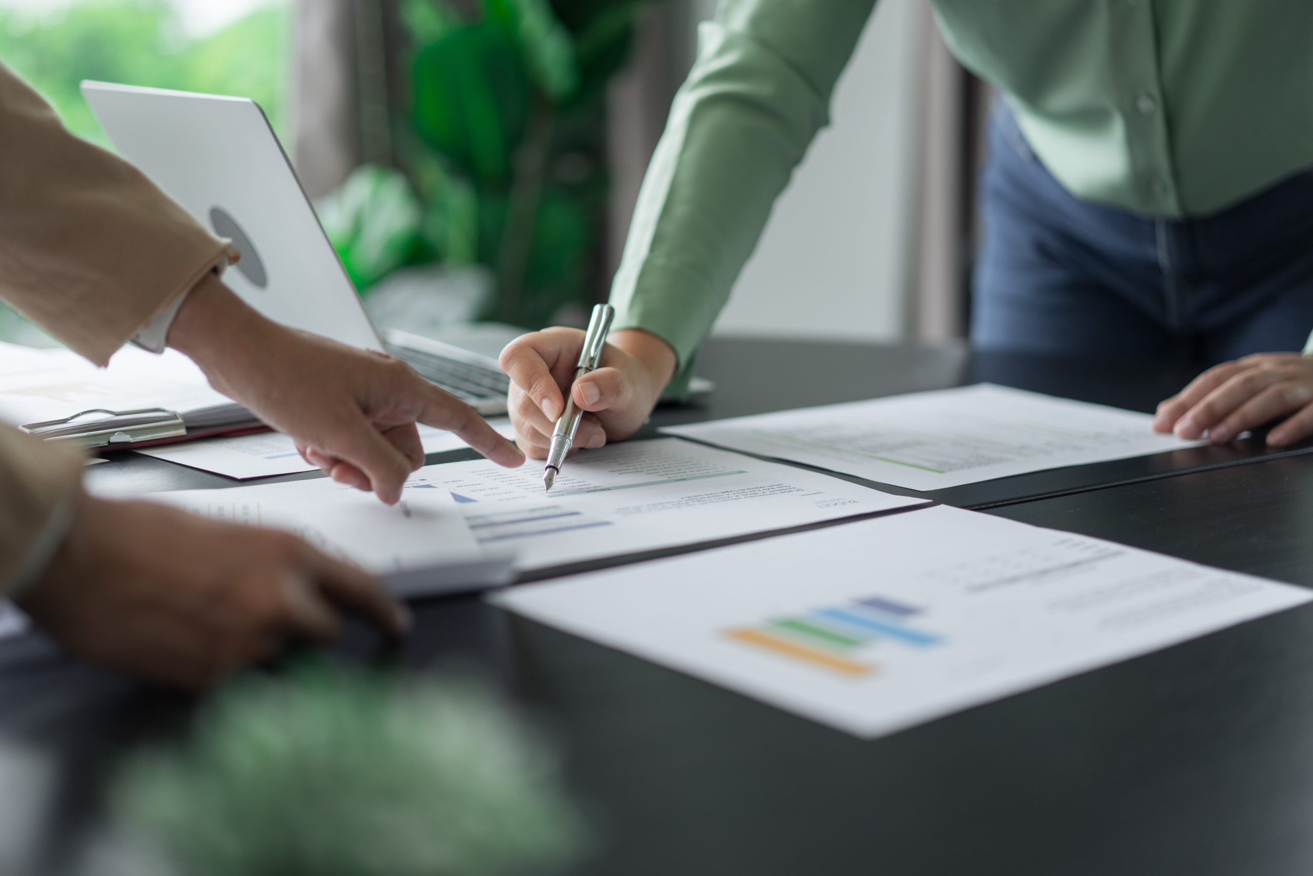 A businesswoman checking and signing documents