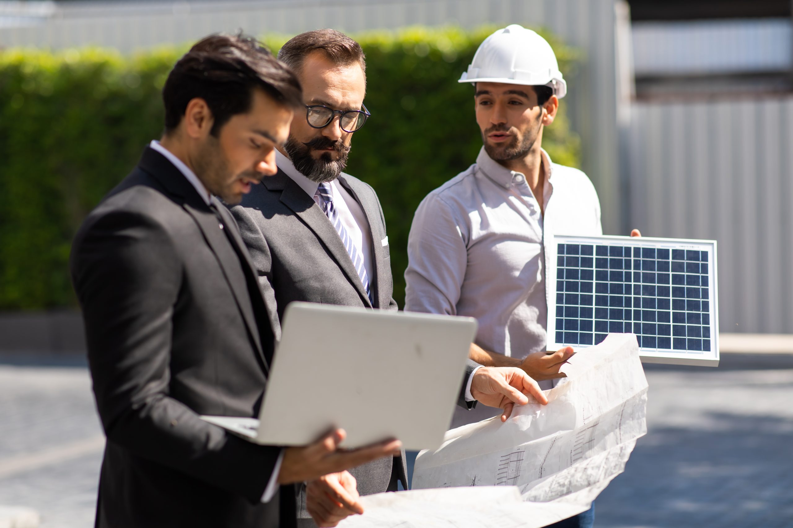 Business professionals discussing solar panel project plans for solar lead generation and attracting quality customers.