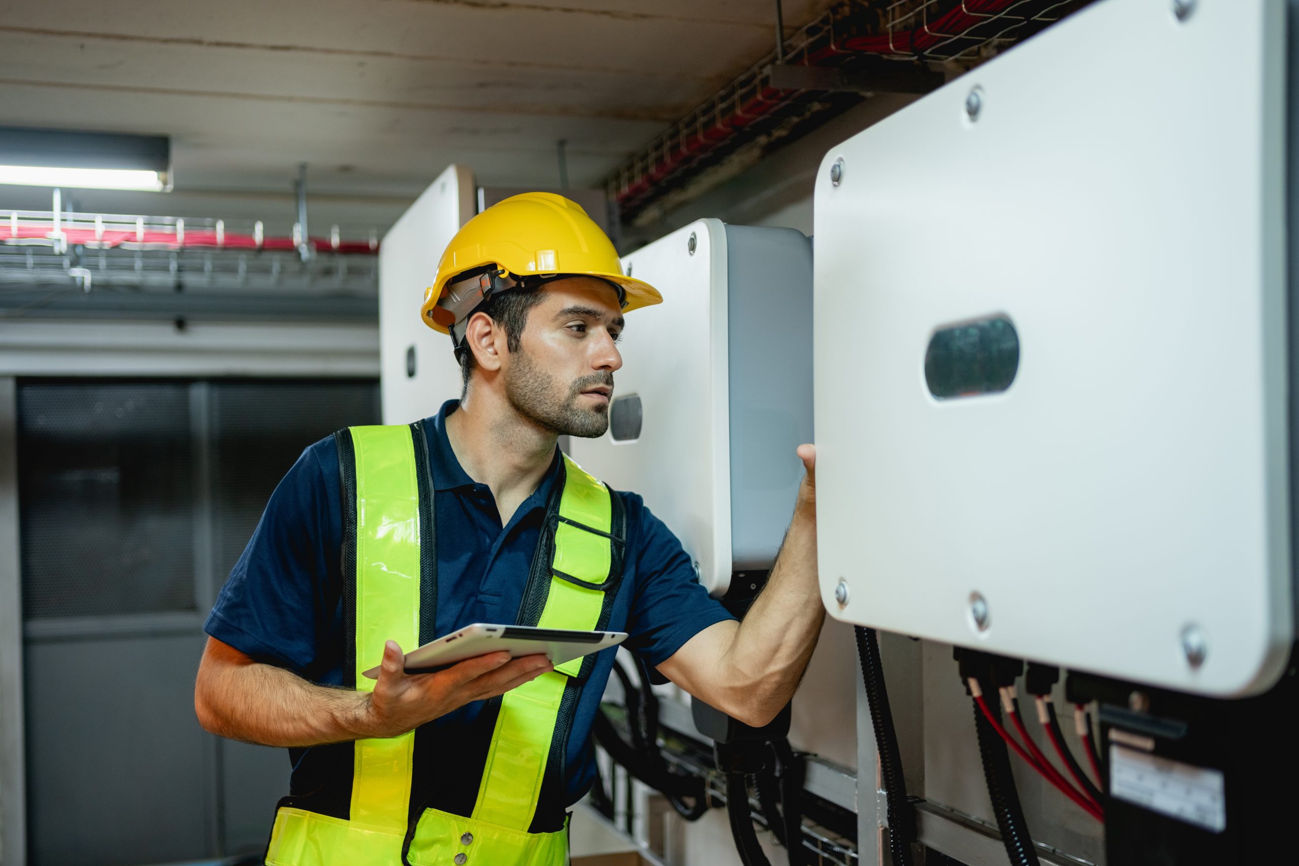 The service engineer checking a solar panel inverter
