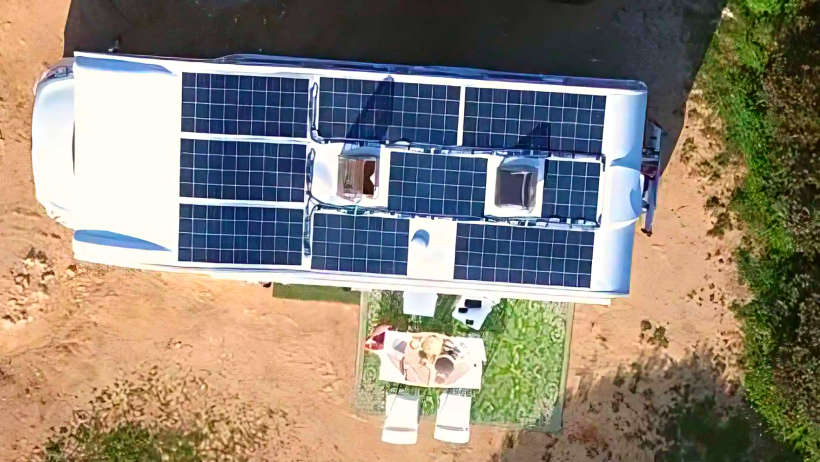 Top-down view of an RV with solar panels installed on the roof, illustrating the use of solar power for mobile and off-grid living
