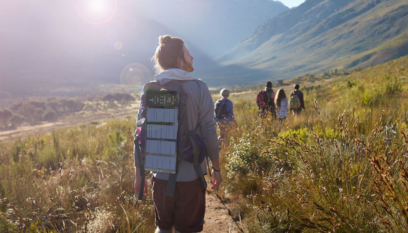 Hikers with solar charger in nature