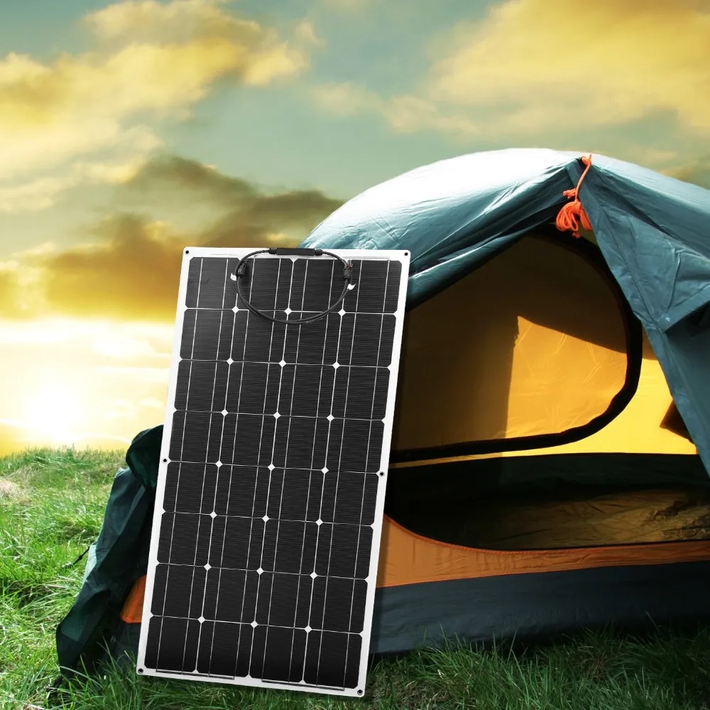 Portable solar panel set up beside a tent at a campsite.