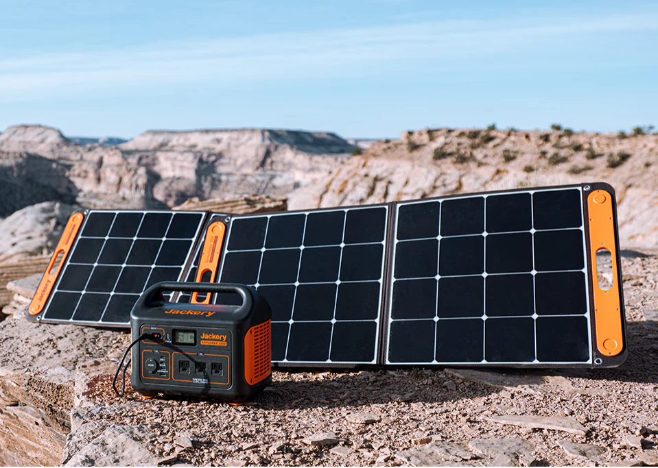 Portable solar power panels connected to a compact power station outdoors, illustrating off-grid solar energy use for travel and backup power.