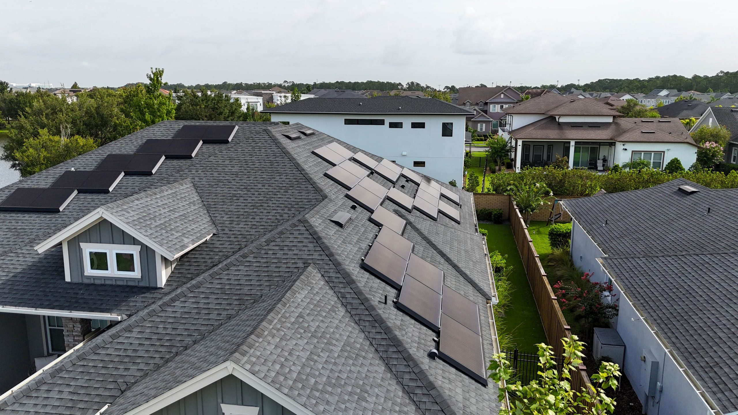A residential rooftop with Tesla Solar Roof shingles installed alongside traditional roofing